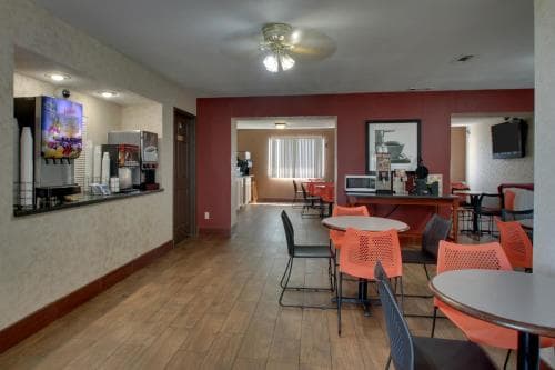 Angel Inn Central in Branson MO breakfast area with tables, chairs, beverage station, and lobby seating