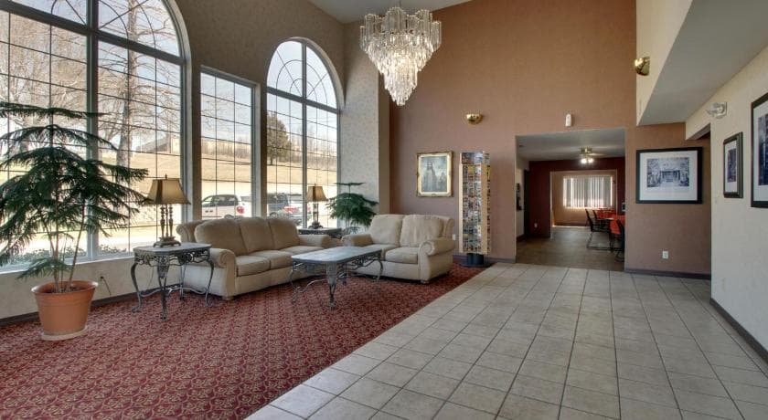 Angel Inn Central hotel lobby in Branson MO with arched windows, chandelier, and seating area